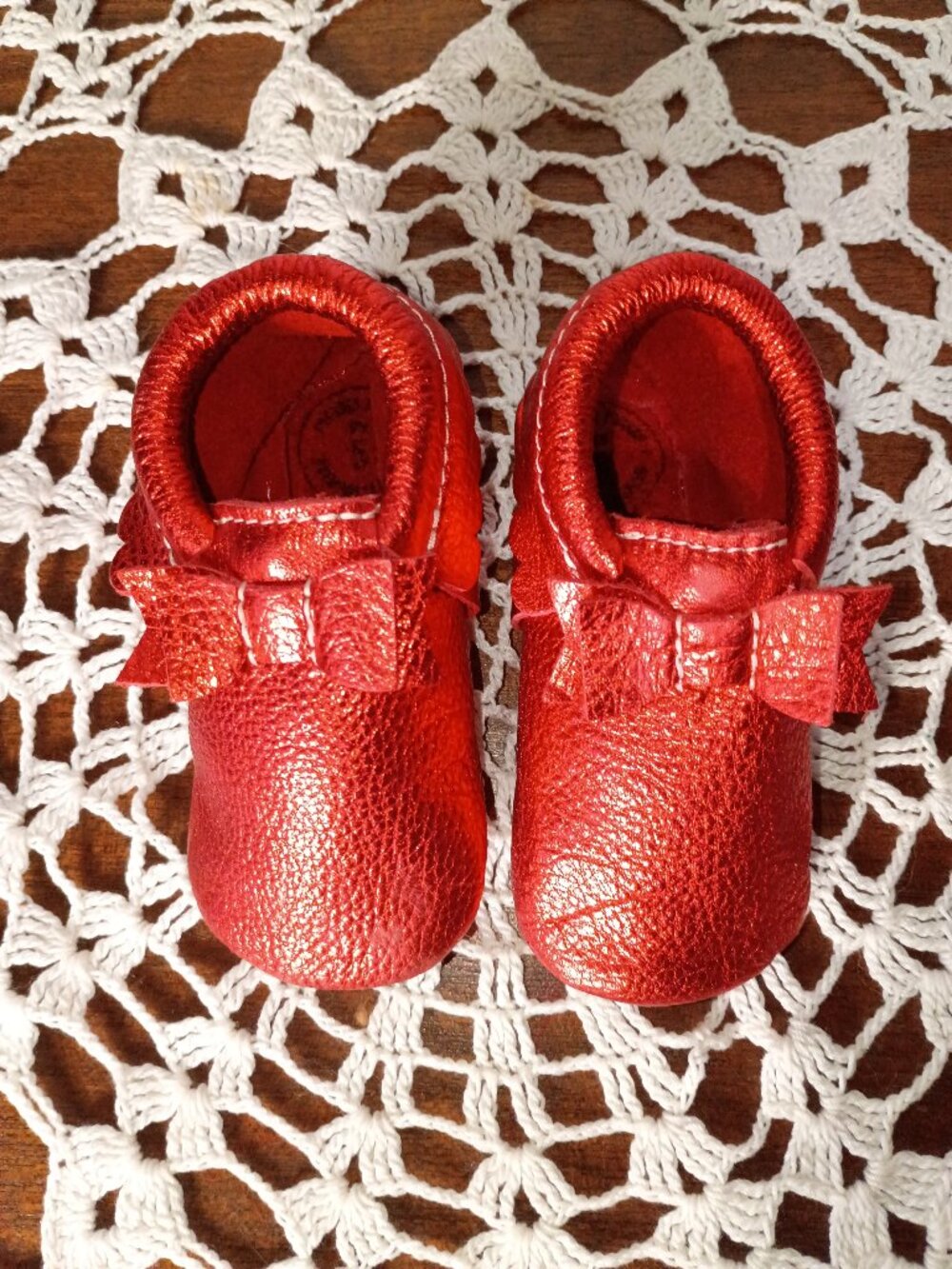 Freshly picked ruby red baby mocassins with bow and ruffles size 5